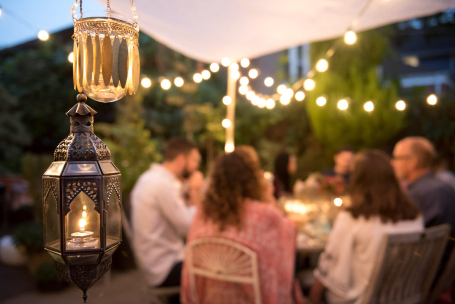 Lanterns hanging with guests in the background